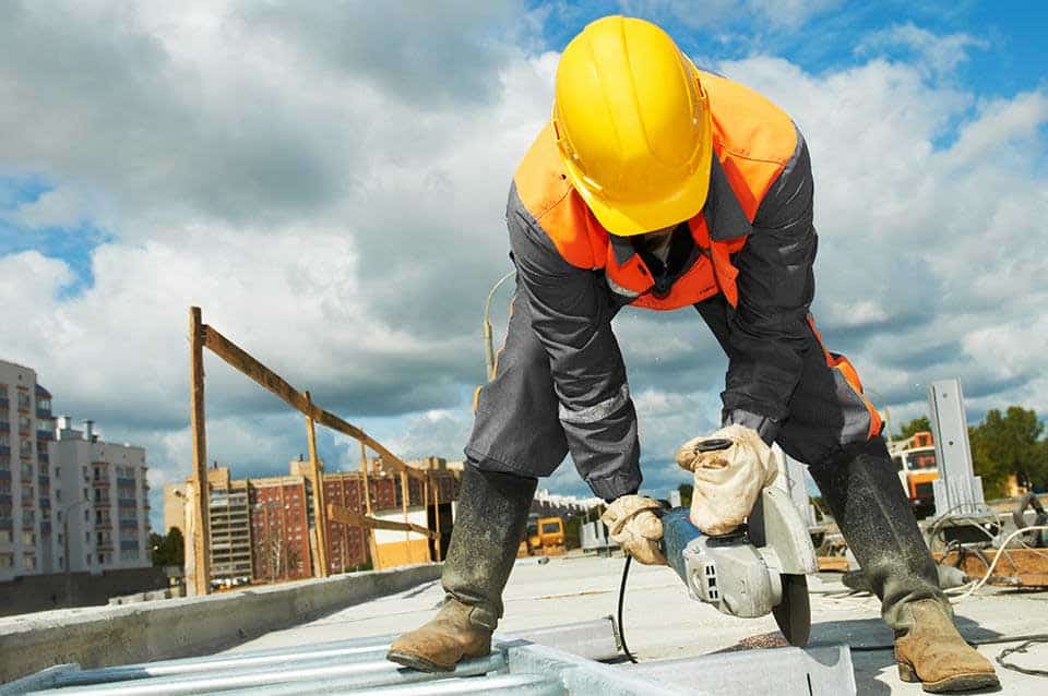 A construction worker cutting stone on a construction site