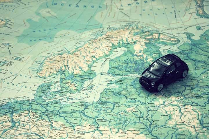 a toy car on top of world map