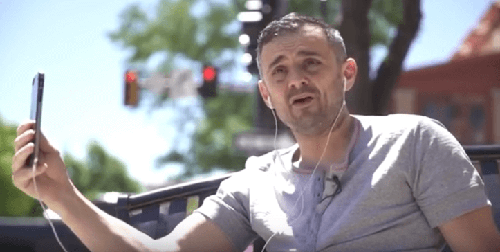 Gary Vaynerchuk using his phone and earphones