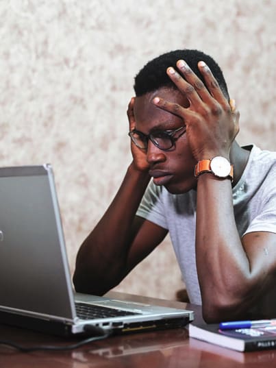 man struggling infront of a laptop