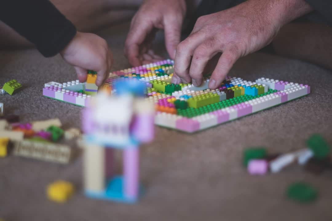father and son building lego buildings